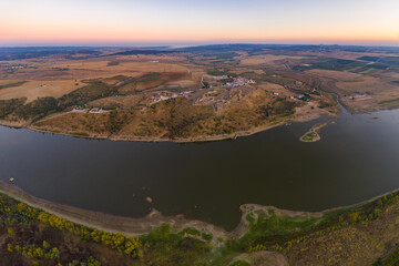 Juromenha castle, village and Guadiana river drone aerial view at sunset in Alentejo, Portugal and Spain on the foreground