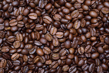 Close up, texture and background of roasted fresh coffee beans