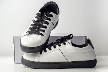 White sneakers with black laces, classic sports shoes