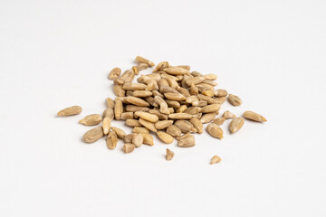 Group of raw organic sunflower seeds without salt close up on neutral grey background