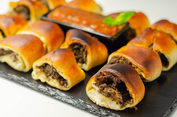 Patty's pies stuffed with minced meat, mushrooms and onion, served with sauce