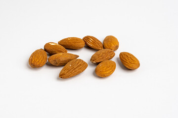 Heap of raw organic Californian almond nuts unshelled and without salt on a neutral background