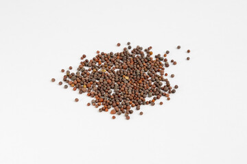 Heap of brown mustard seeds on a neutral background