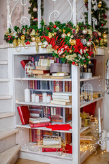 Room with a large library of books with a Christmas decor