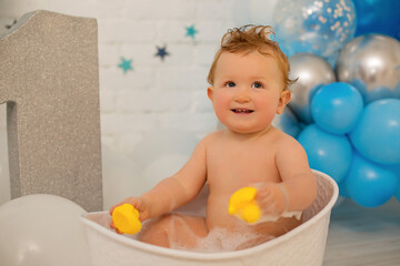 Happy laughing baby taking a bath playing