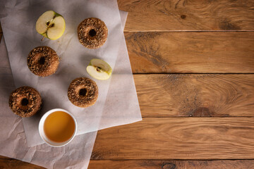Apple cider donuts with ingredients on table