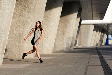 young attractive woman in short dress running