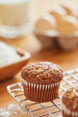 Muffin with making products on table.