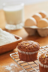 Muffin with making products on table.