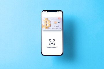 Bitcoin paying symbol. Bank bitcoin cryptocurrency card in hovering smartphone screen. Shopping and trading bitcoin concept.
