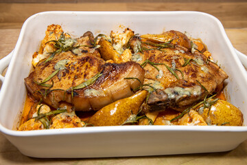 A delicious dish of Pork Pear sweet potato and stilton tray roast on a wooden kitchen work top