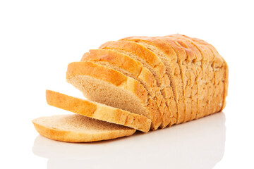 The cut loaf of wheat bread with reflection isolated on white