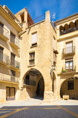 Fototapeta na wymiar Entrance to the arcaded square of the historic center of Calaceite, Teruel, Spain
