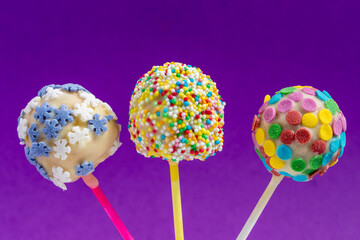 homemade colorful cake pops on purple background