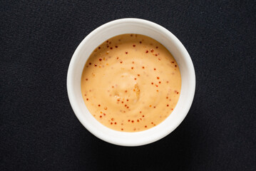 sauce in the bowl on the black background