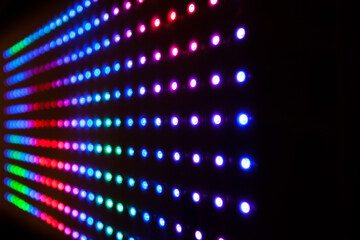 Colourful RGB LED lights on black background. LED Matrix with WS2812B strips. Playing animations...