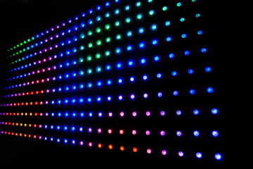 Colourful RGB LED lights on black background. LED Matrix with WS2812B strips. Playing animations and effects on digital LED display. Rainbow colours. 