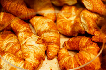 Fresh mouth-watering croissants on the counter. Close-up. Selective focus.