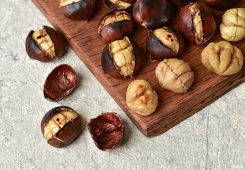 Roasted chestnut on wooden table.