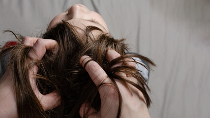 mom gives head massage to daughter at home top view