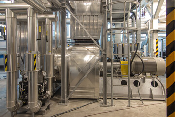 fan with a large electric motor and  ducts and pipes