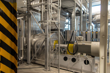 fan with a large electric motor and  ducts and pipes