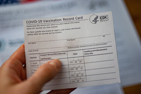 Washington, DC, USA - December, 23,2020: Close Up View Of Blurred COVID-19 Vaccination Record Card By CDC In Hand.