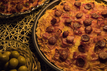 Bacon, sausage, oregano ​​and cheese pizza with olives