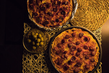 Bacon, sausage, oregano ​​and cheese pizza with olives