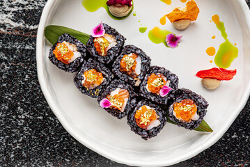 Obraz na płótnie Canvas creative sushi with gold and petals