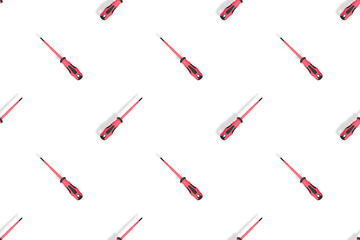 Screwdrivers seamless pattern. Metal screwdrivers with a rubberized handle on a white background.