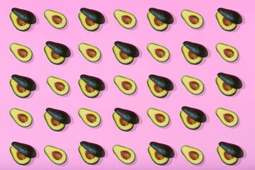 Trendy avocado pattern on light pink background.