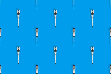 Screwdrivers seamless pattern. Metal screwdrivers with a rubberized handle on a blue background.