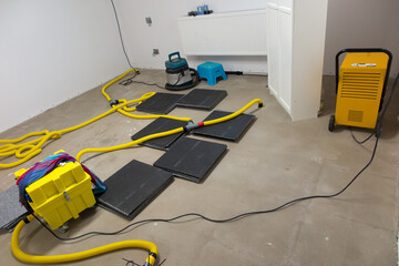 Drying a concrete floor under a fabric covering.