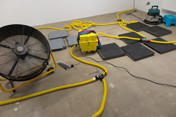 Drying a concrete floor under a fabric covering.
