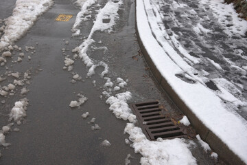 9 - Curb and snowy pavement curves through the image, with snow melt
