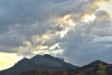 clouds over the mountain tops at sunset