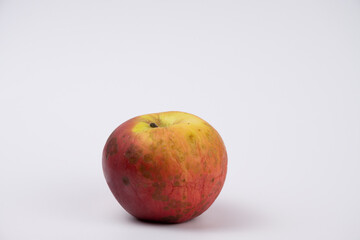 Dirty red apple, almost spoiled
