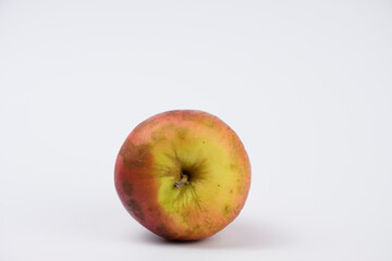 Dirty red apple, almost spoiled