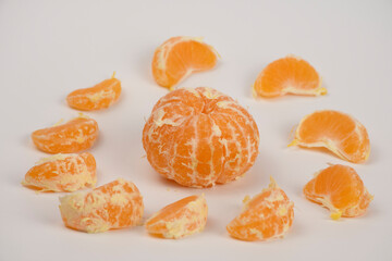 Orange tangerines, slices close-up isolated on white background