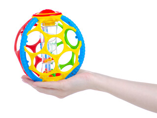 Baby rattle toy ball in hand on white background isolation