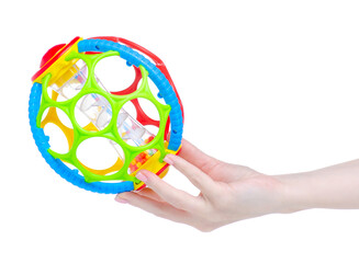 Baby rattle toy ball in hand on white background isolation