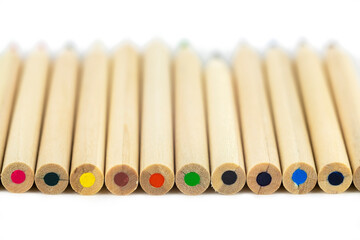 light wooden pencils with colored leads close up isolated on white blurred background
