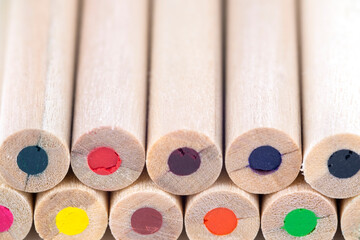 light wooden colored pencils close up on blurred background