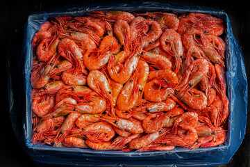 Lots of frozen prawns in a box. Seafood healthy. 