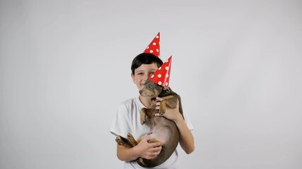 Boy with a dog and a cap. Birthday. post messages or various advertising banners. Boy in a white t-shirt, copy space. Happy boy. 4K resolution - Powered by Adobe