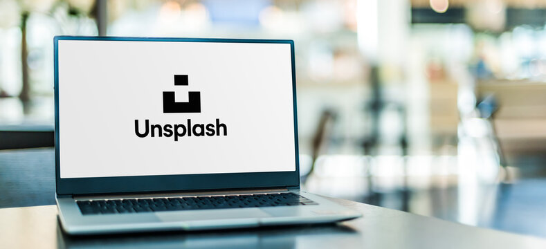 Laptop computer displaying logo of Unsplash