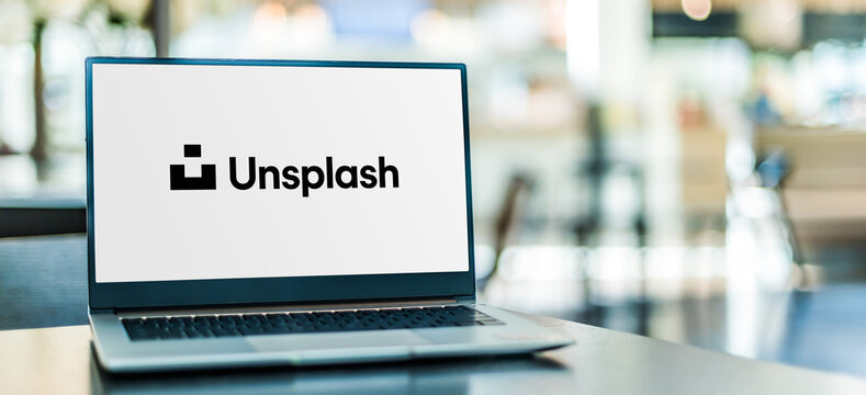 Laptop computer displaying logo of Unsplash