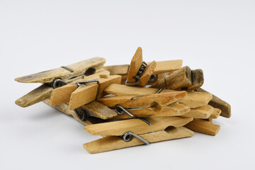 Wooden clothes pegs isolated on white background