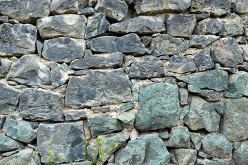 Background with a fragment of a stone wall of an ancient armenian monastery